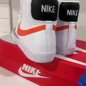 Nike Kids White Sneakers with Orange Swoosh